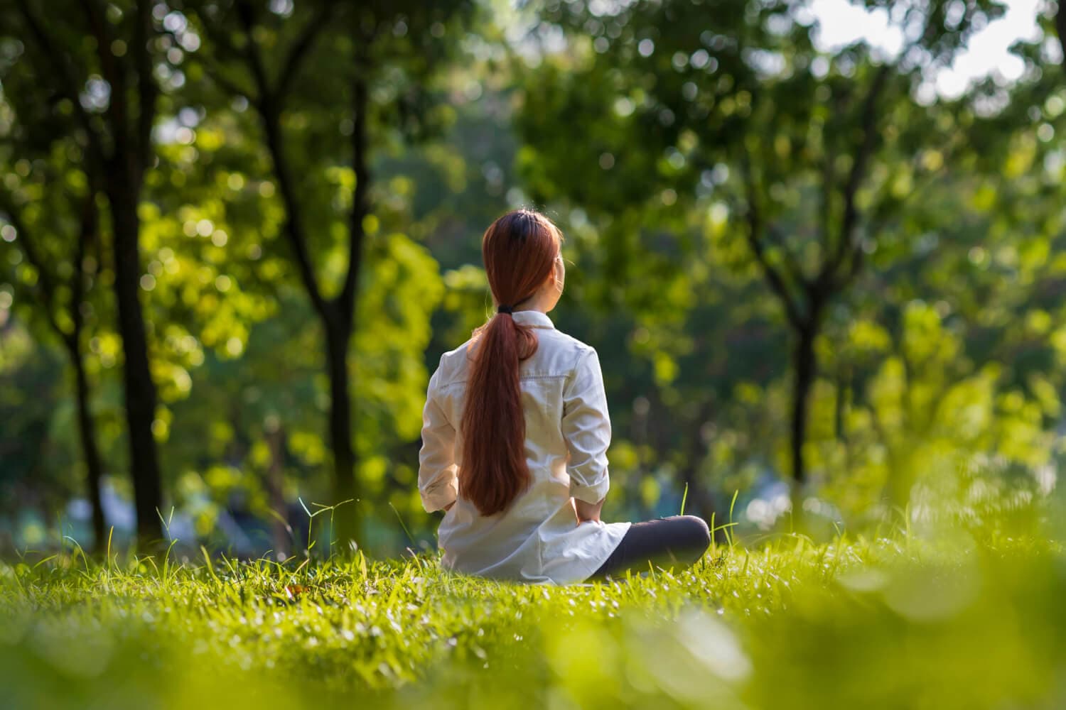 Woman meditating in the grass